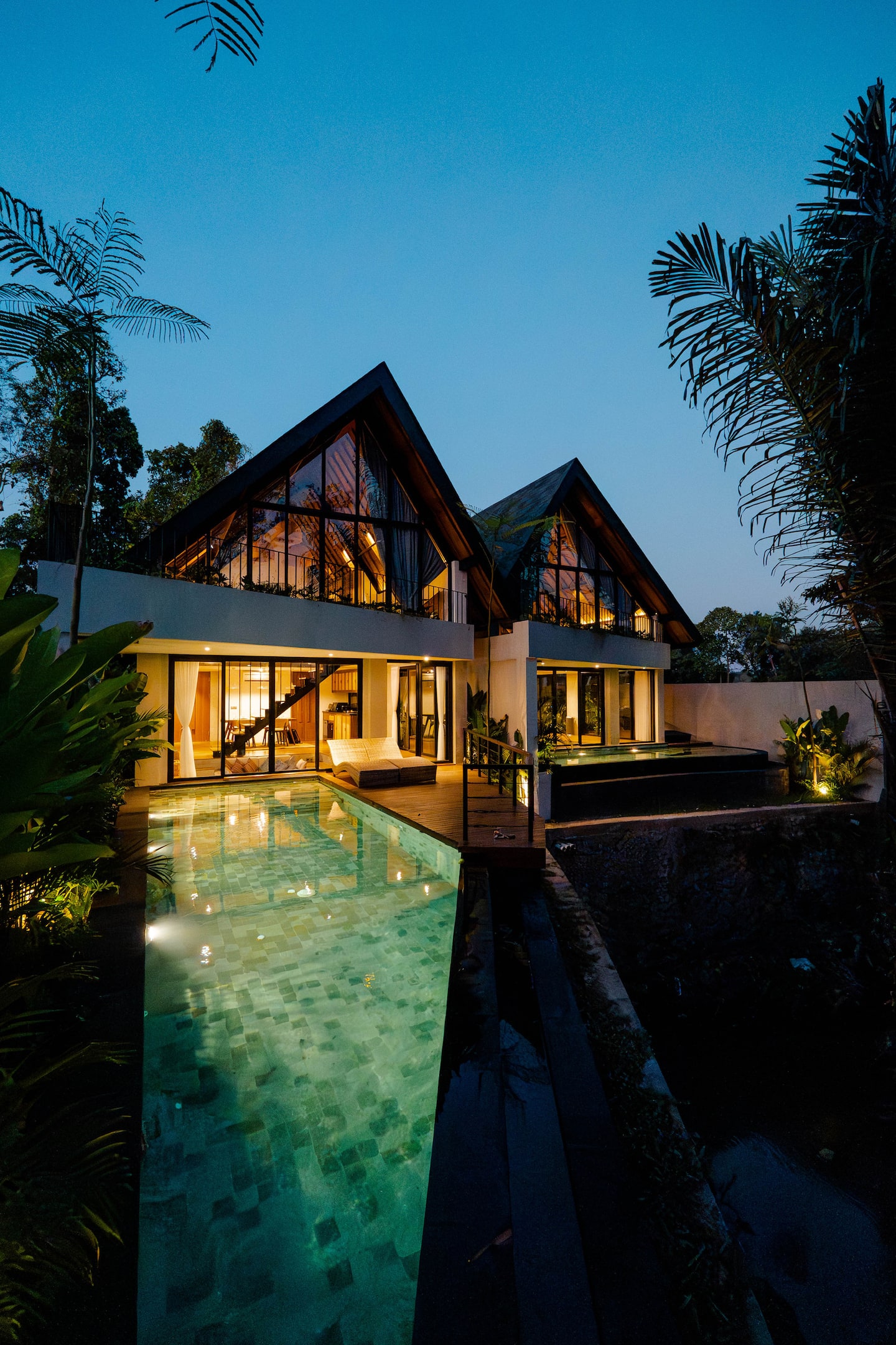 Villa Astu exterior at twilight, pool glowing