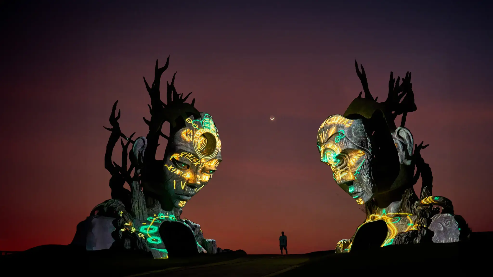 The Sentinels, illuminated sculptures at Nuanu Creative City at dusk