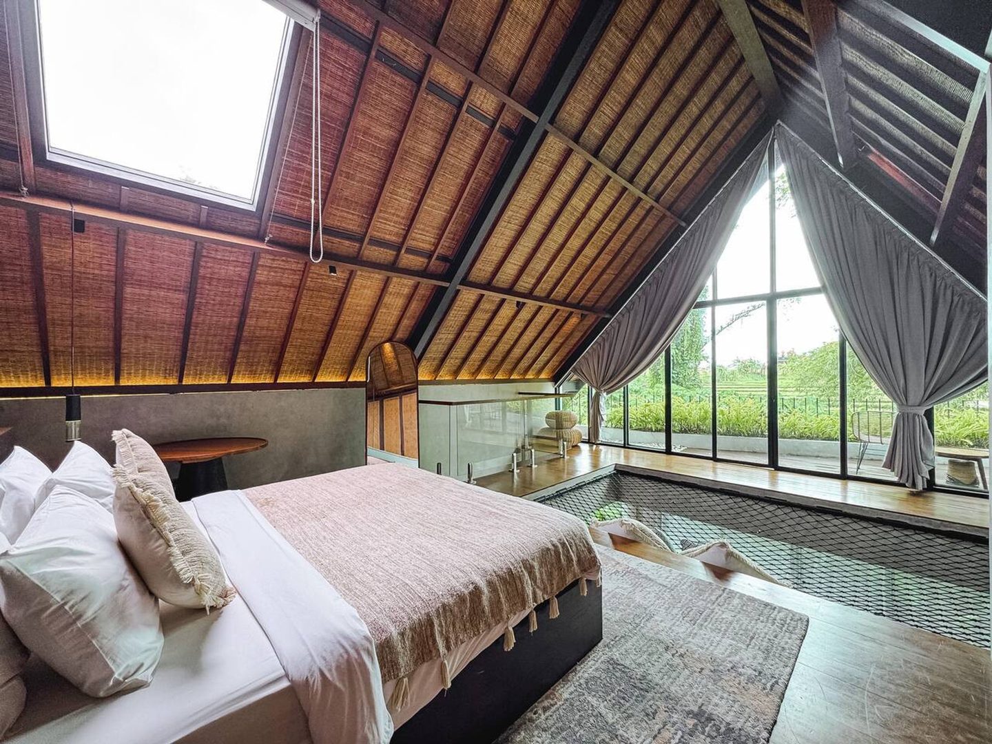 Bed facing the gable window over the pool
